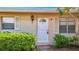 Charming front door with white trim, shutters, and landscaped bushes at 2188 Corinne S Ct # A, St Petersburg, FL 33712