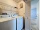 Laundry room featuring a white washer and dryer, wire shelves, and a door to another room at 2188 Corinne S Ct # A, St Petersburg, FL 33712
