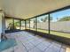 Enclosed patio with tiled floor and screened windows overlooking the backyard at 2188 Corinne S Ct # A, St Petersburg, FL 33712
