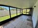 Tiled floor patio with screening featuring views of the yard and trees at 2188 Corinne S Ct # A, St Petersburg, FL 33712
