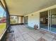 Enclosed patio with tiled floor and screened windows overlooking the backyard at 2188 Corinne S Ct # A, St Petersburg, FL 33712