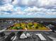Stunning aerial view showcasing the expansive property with a house, barn, pond, and lush greenery at 22803 67Th E Ave, Bradenton, FL 34211