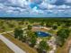 Stunning aerial view of estate featuring private pond with fountain, surrounded by lush greenery at 22803 67Th E Ave, Bradenton, FL 34211