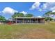 Barn exterior featuring open stalls, ideal for livestock and equestrian enthusiasts at 22803 67Th E Ave, Bradenton, FL 34211