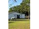Equestrian property featuring a charming white barn and a horse grazing peacefully in the green pasture at 22803 67Th E Ave, Bradenton, FL 34211