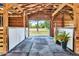 Well-maintained barn interior featuring wood beams, sturdy stalls, and an open view to the green pasture at 22803 67Th E Ave, Bradenton, FL 34211