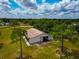 Spacious barn with high ceilings and a large open entrance, surrounded by lush greenery and mature trees at 22803 67Th E Ave, Bradenton, FL 34211
