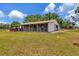 Exterior view of horse barn, featuring open-air stalls, providing ample space and comfort for livestock on a private property at 22803 67Th E Ave, Bradenton, FL 34211