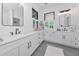 A stylish bathroom with a double vanity, great lighting, and windows for this space of relaxation at 22803 67Th E Ave, Bradenton, FL 34211