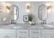 Bathroom with double sinks, stone countertop, modern fixtures, and decorative accents for a spa-like feel at 22803 67Th E Ave, Bradenton, FL 34211