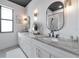 Bathroom with double sinks, stone countertop, modern fixtures, and decorative accents for a spa-like feel at 22803 67Th E Ave, Bradenton, FL 34211