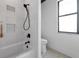 Bathroom with white tile, shower with black hardware, and a modern toilet with stylish design at 22803 67Th E Ave, Bradenton, FL 34211