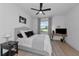 Bedroom features a cozy bed with decorative pillows, ceiling fan, and a window with calming views at 22803 67Th E Ave, Bradenton, FL 34211