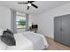 Bedroom features a cozy bed, ceiling fan, a window, and a wardrobe cabinet at 22803 67Th E Ave, Bradenton, FL 34211