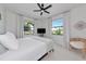 Inviting bedroom features a modern ceiling fan, bright lighting, and natural light for comfort and ambiance at 22803 67Th E Ave, Bradenton, FL 34211