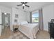 Bright bedroom features a ceiling fan and a window showcasing outdoor views, neutral tones at 22803 67Th E Ave, Bradenton, FL 34211