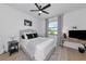 Bedroom features a cozy bed with decorative pillows, ceiling fan, and a window with calming views at 22803 67Th E Ave, Bradenton, FL 34211
