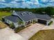 Aerial view of home highlighting a pristine exterior, well-manicured lawn, and extended driveway with garage at 22803 67Th E Ave, Bradenton, FL 34211