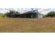 Home's backyard featuring a screened patio, offering a perfect blend of indoor and outdoor living at 22803 67Th E Ave, Bradenton, FL 34211