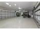 Spacious garage featuring speckled epoxy flooring, tall shelving, and ample room for storage and vehicles at 22803 67Th E Ave, Bradenton, FL 34211