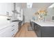 Modern kitchen with stainless steel appliances, white cabinets, long island and bright natural light at 22803 67Th E Ave, Bradenton, FL 34211