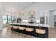 Spacious kitchen featuring a large island with seating, modern appliances, and stylish pendant lighting at 22803 67Th E Ave, Bradenton, FL 34211