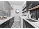 Chic laundry room with black cabinets, white countertops, and patterned tile flooring at 22803 67Th E Ave, Bradenton, FL 34211
