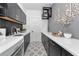 Well-equipped laundry room with black cabinets, quartz countertops, and stylish tile flooring at 22803 67Th E Ave, Bradenton, FL 34211