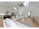 Open-concept living room and kitchen with high ceilings, skylights, and light wood floors at 22803 67Th E Ave, Bradenton, FL 34211