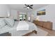 Spacious main bedroom with a ceiling fan, light wood floors and access to the pool at 22803 67Th E Ave, Bradenton, FL 34211