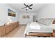 This is a bright bedroom featuring a ceiling fan, accent lighting, and decor to add to the room's ambiance at 22803 67Th E Ave, Bradenton, FL 34211