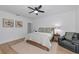 The large bedroom has a ceiling fan, natural light, and hardwood flooring for comfort and style at 22803 67Th E Ave, Bradenton, FL 34211