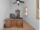Bright home office featuring a wooden desk, ceiling fan, shelving, and window with shutter blinds at 22803 67Th E Ave, Bradenton, FL 34211