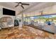 Enclosed outdoor patio offers comfortable seating, ceiling fans, and views of the large backyard at 22803 67Th E Ave, Bradenton, FL 34211