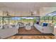 Covered patio features neutral colored furniture and overlooks the property's green landscape at 22803 67Th E Ave, Bradenton, FL 34211