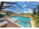 Backyard pool with hot tub inside of a screened enclosure; perfect for relaxing and entertaining at 22803 67Th E Ave, Bradenton, FL 34211