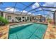 Exterior of home and backyard pool, showcasing ample seating and outdoor lounge area at 22803 67Th E Ave, Bradenton, FL 34211