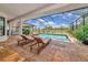 Relaxing pool area featuring lounge chairs and stunning views of the backyard's green landscape at 22803 67Th E Ave, Bradenton, FL 34211