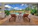 Relaxing pool area with lounge chairs, complemented by lush landscaping and an expansive view of the property at 22803 67Th E Ave, Bradenton, FL 34211