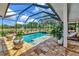 Outdoor pool with a hot tub and a screened enclosure with nice landscaping around at 22803 67Th E Ave, Bradenton, FL 34211