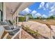 Relaxing covered front porch featuring comfortable seating, ideal for enjoying the serene views of the expansive property at 22803 67Th E Ave, Bradenton, FL 34211