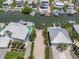 Breathtaking aerial view of waterfront homes with private docks and lush landscaping along a tranquil canal at 229 S Harbor Dr, Holmes Beach, FL 34217