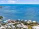 Breathtaking aerial view featuring bayfront homes against vast ocean and sky at 229 S Harbor Dr, Holmes Beach, FL 34217