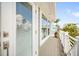 View from a charming balcony featuring white railings and a partial view of the surrounding neighborhood at 229 S Harbor Dr, Holmes Beach, FL 34217