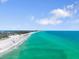 Beautiful beach with clear turquoise water and clear skies filled with people enjoying the sun at 229 S Harbor Dr, Holmes Beach, FL 34217