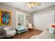 Cozy bedroom featuring neutral tones, a ceiling fan, and a window with plantation shutters at 229 S Harbor Dr, Holmes Beach, FL 34217