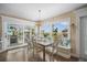 Bright dining area featuring a stylish chandelier, a view, and a comfortable seating nook at 229 S Harbor Dr, Holmes Beach, FL 34217