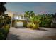 Beautiful two-story house with a double garage and a lovely balcony, complemented by lush greenery at 229 S Harbor Dr, Holmes Beach, FL 34217