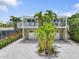 Inviting home with double garage, mature landscaping, and a cozy balcony, perfect for relaxation at 229 S Harbor Dr, Holmes Beach, FL 34217