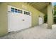 Garage exterior with white doors, a gravel driveway, and SEAQUEL sign at 229 S Harbor Dr, Holmes Beach, FL 34217